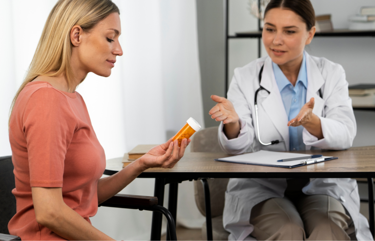 Doctor consulting a patient holding a prescription pill bottle during a medical appointment.