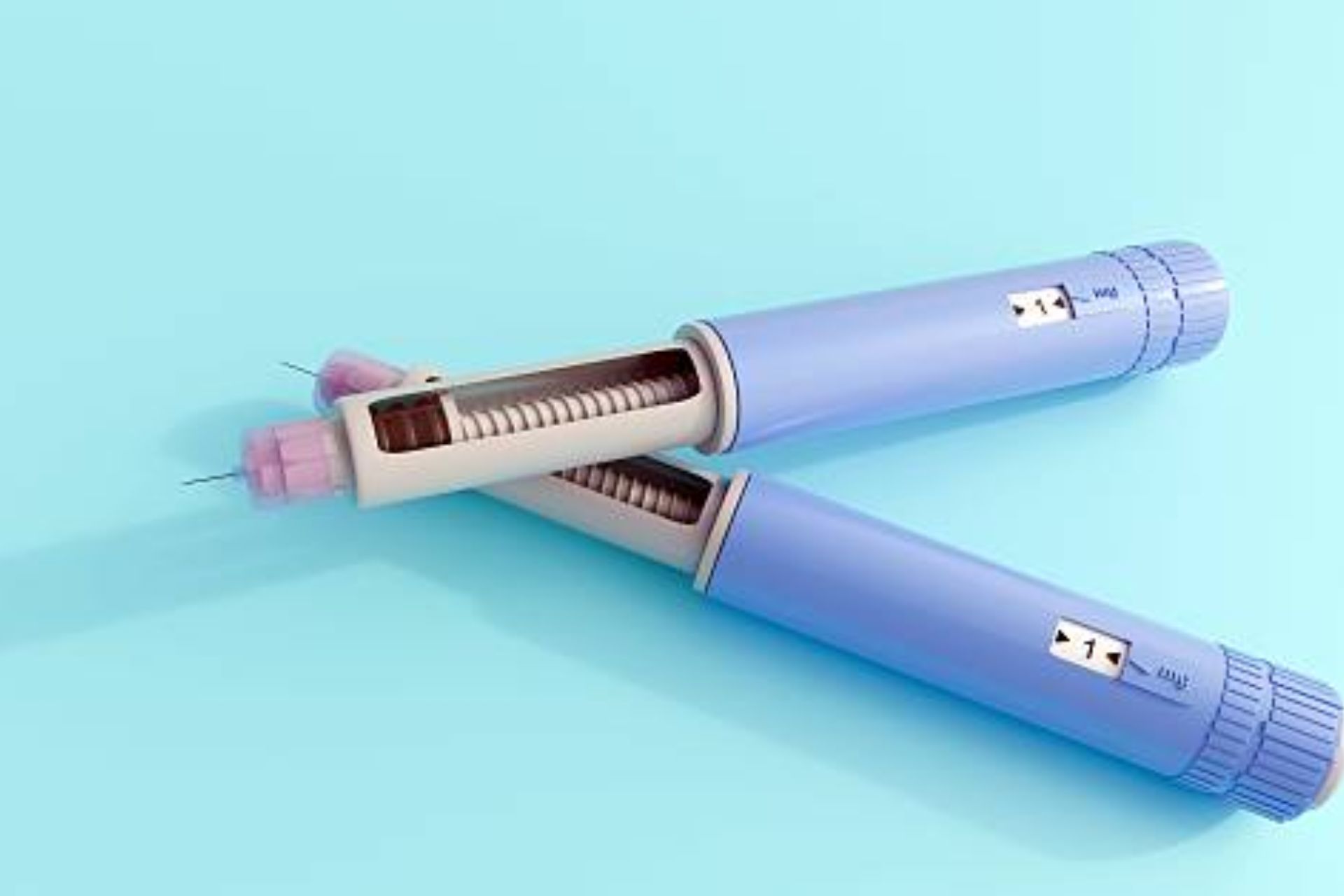 Two blue GLP-1 injection pens used for weight loss and diabetes treatment placed on a light blue background.
