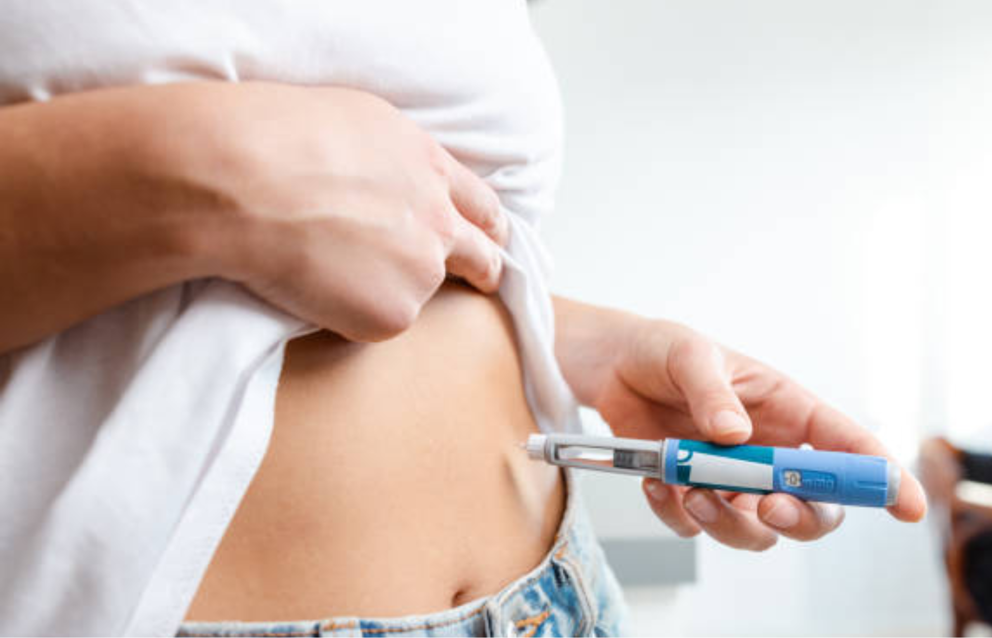 Person injecting GLP-1 medication into abdomen using a prefilled pen