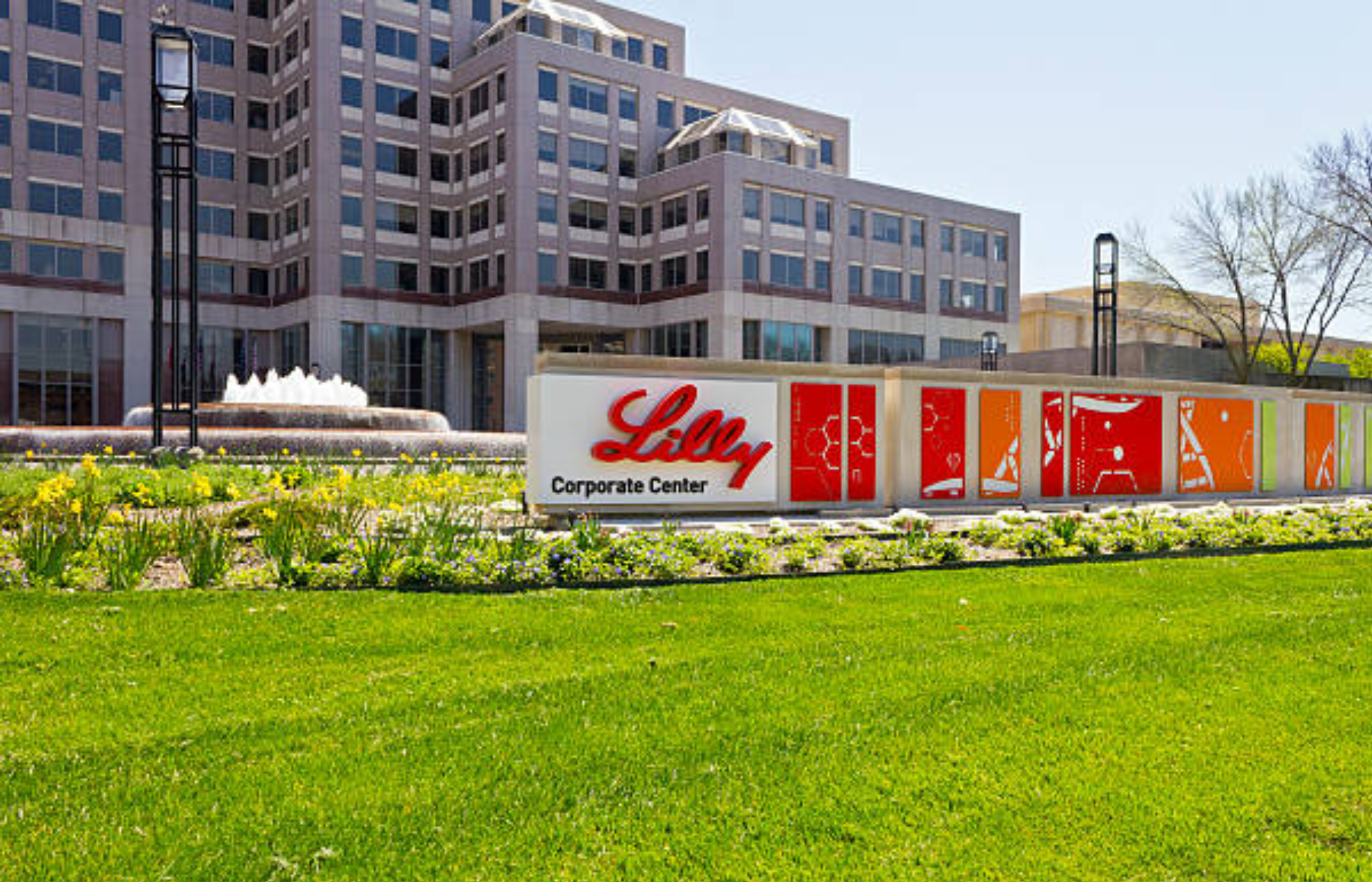Eli Lilly corporate center building with logo sign and landscaped grounds