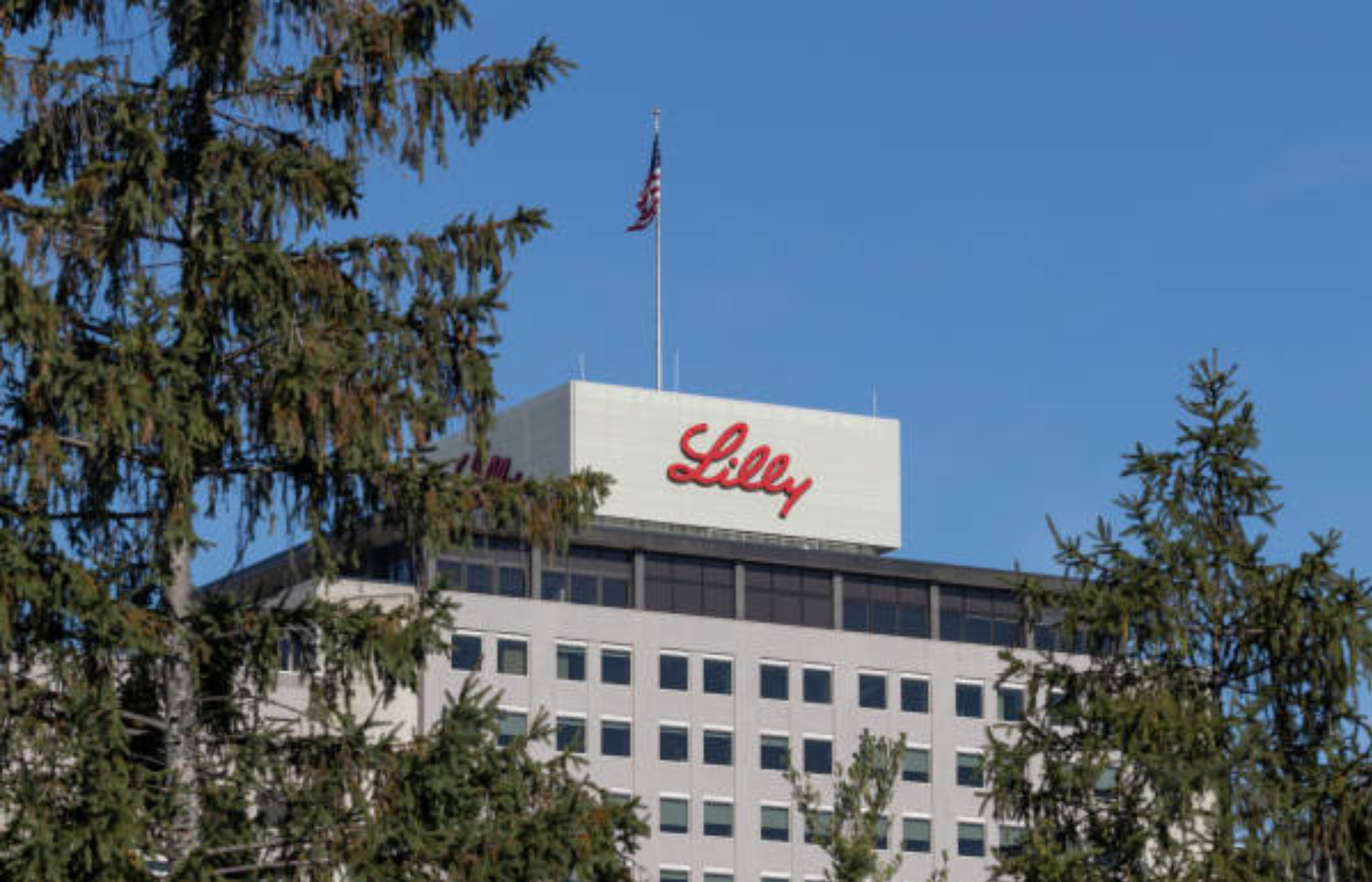Eli Lilly headquarters building with company logo and U.S. flag