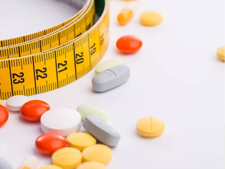 Measuring tape around scattered book pages and a tablet screen