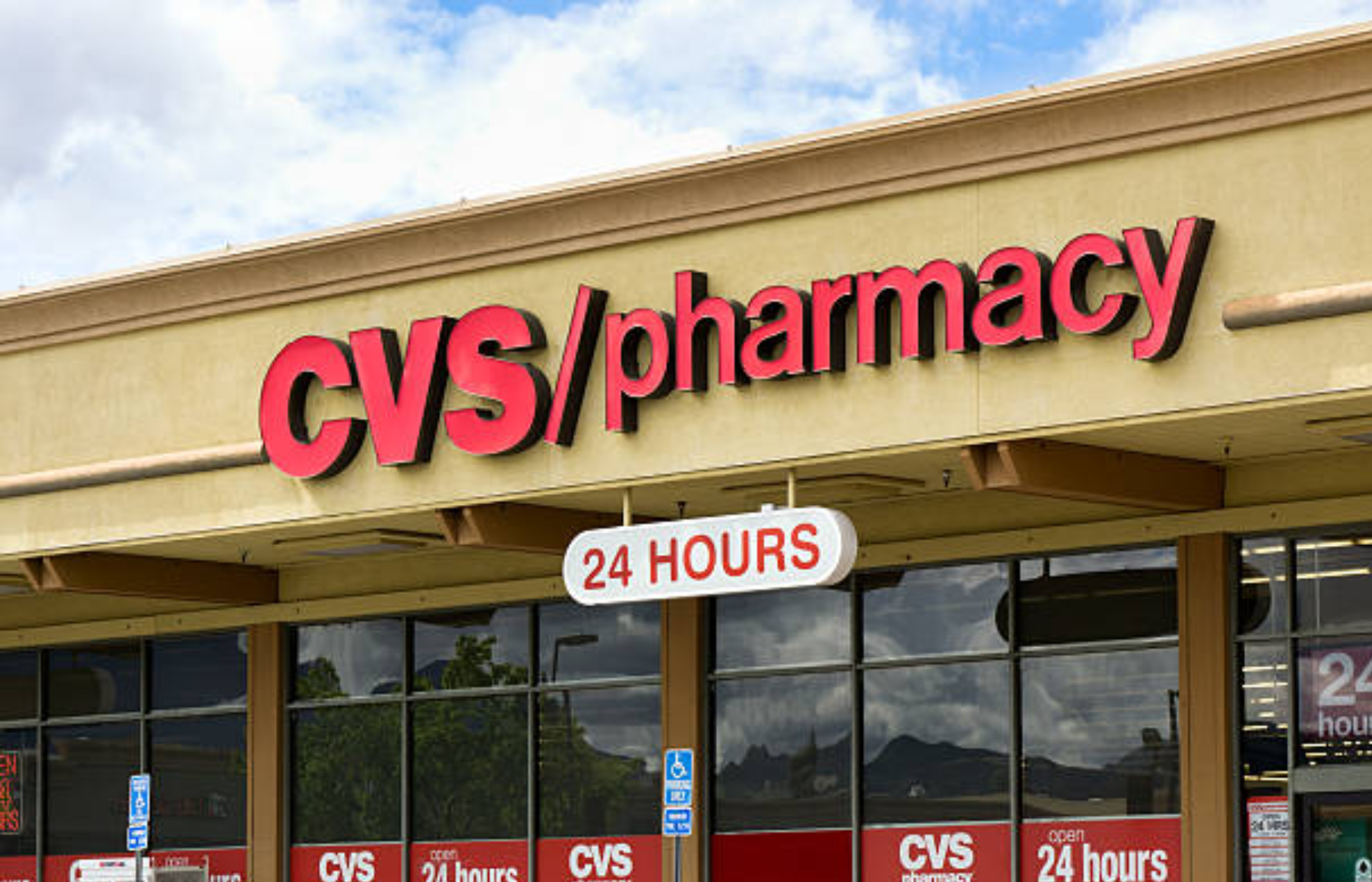 CVS Pharmacy storefront with large red CVS/pharmacy signage and 24-hour service display.