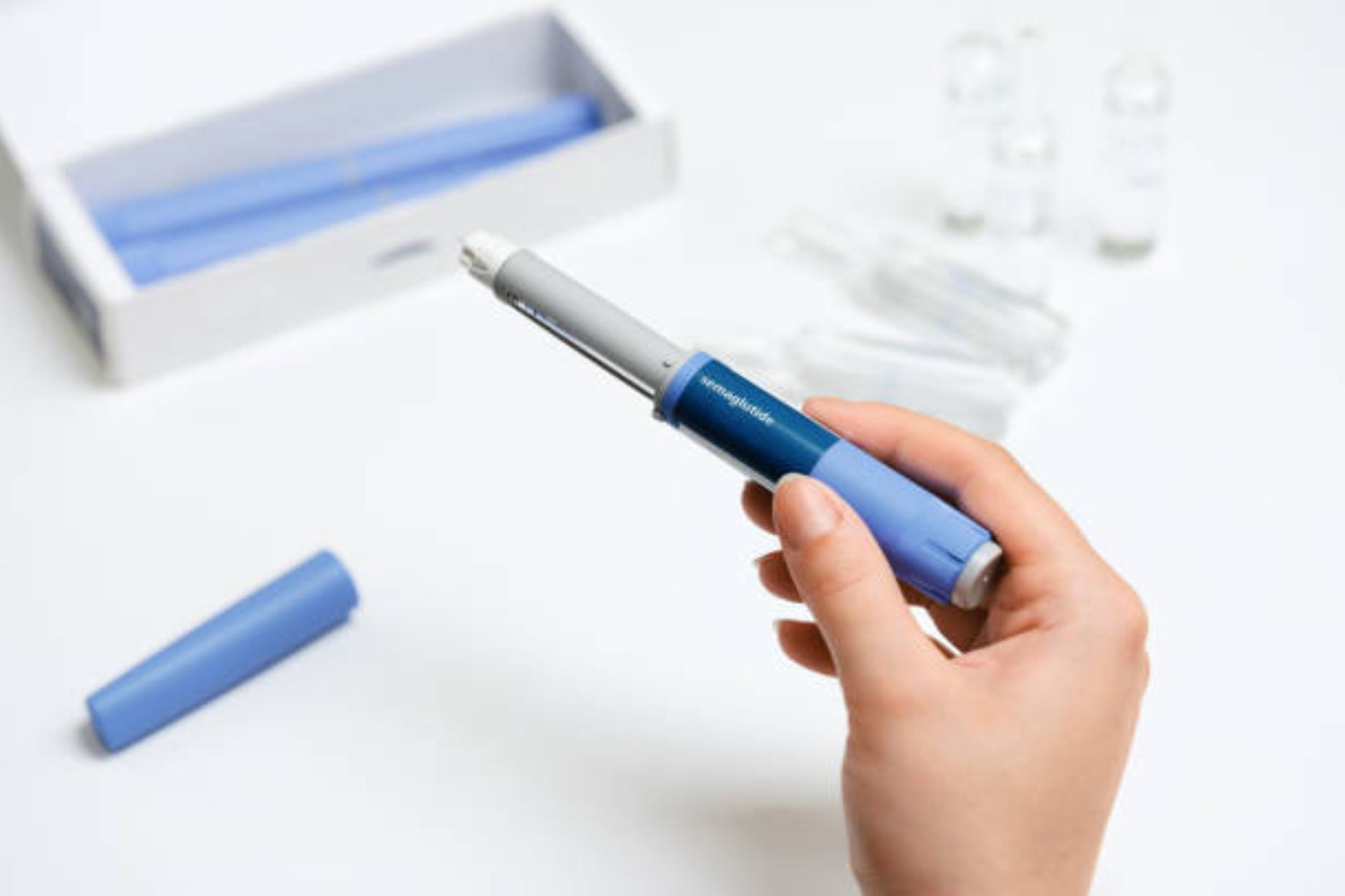 Hand holding a GLP-1 injection pen used for diabetes or weight loss treatment