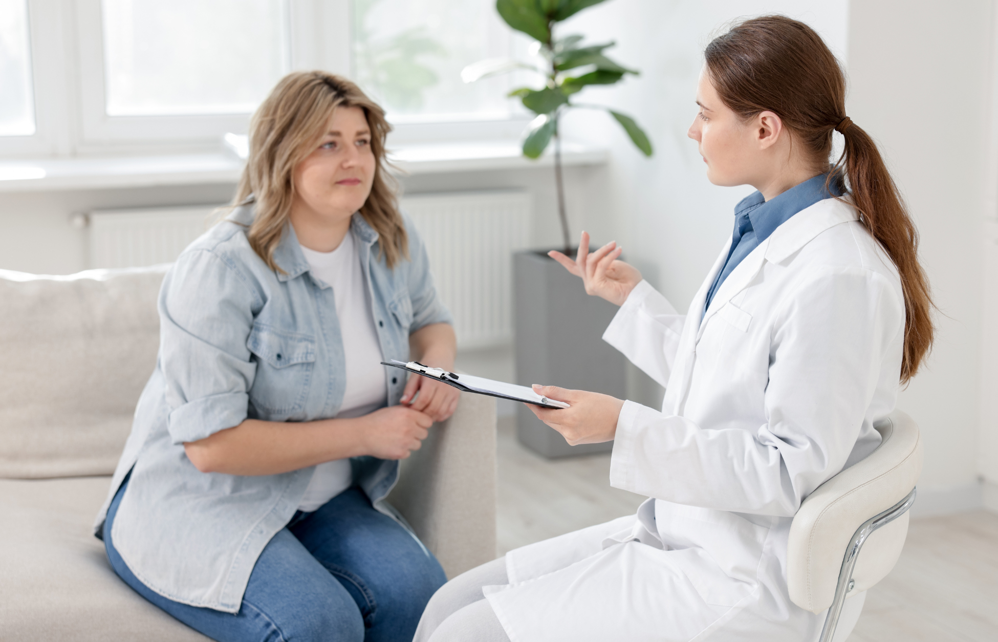 Doctor consulting with an overweight female patient during a follow-up visit in a medical clinic.