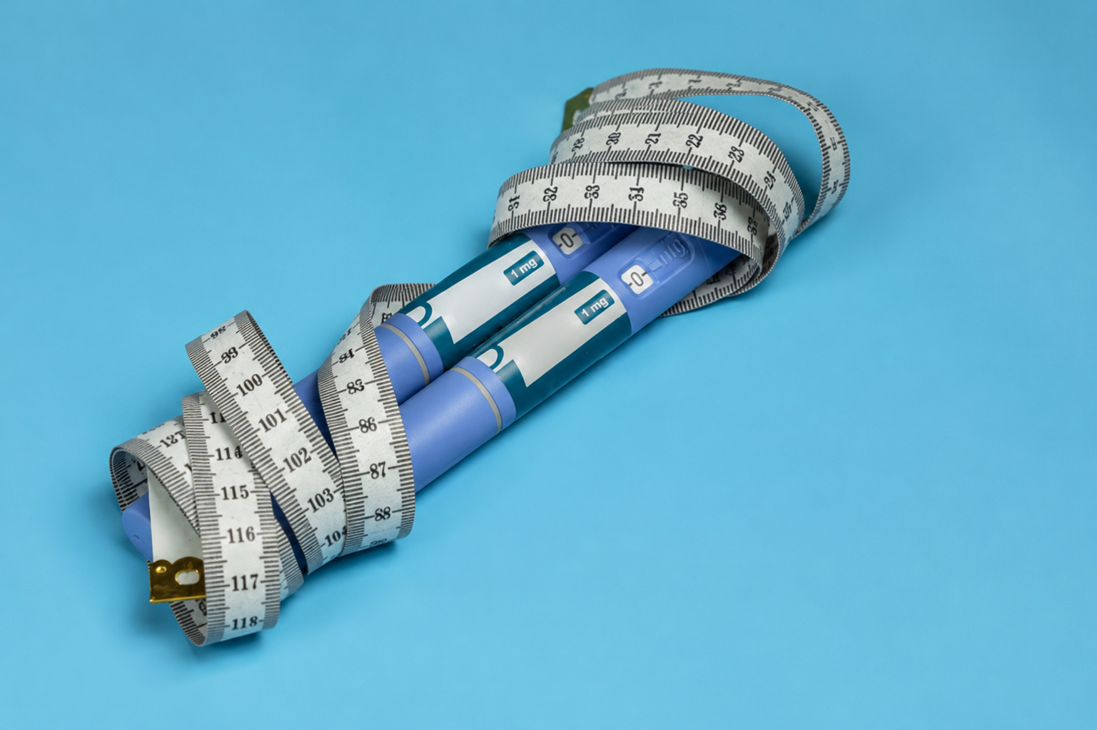 Wegovy pens and measuring tape symbolizing weight management.