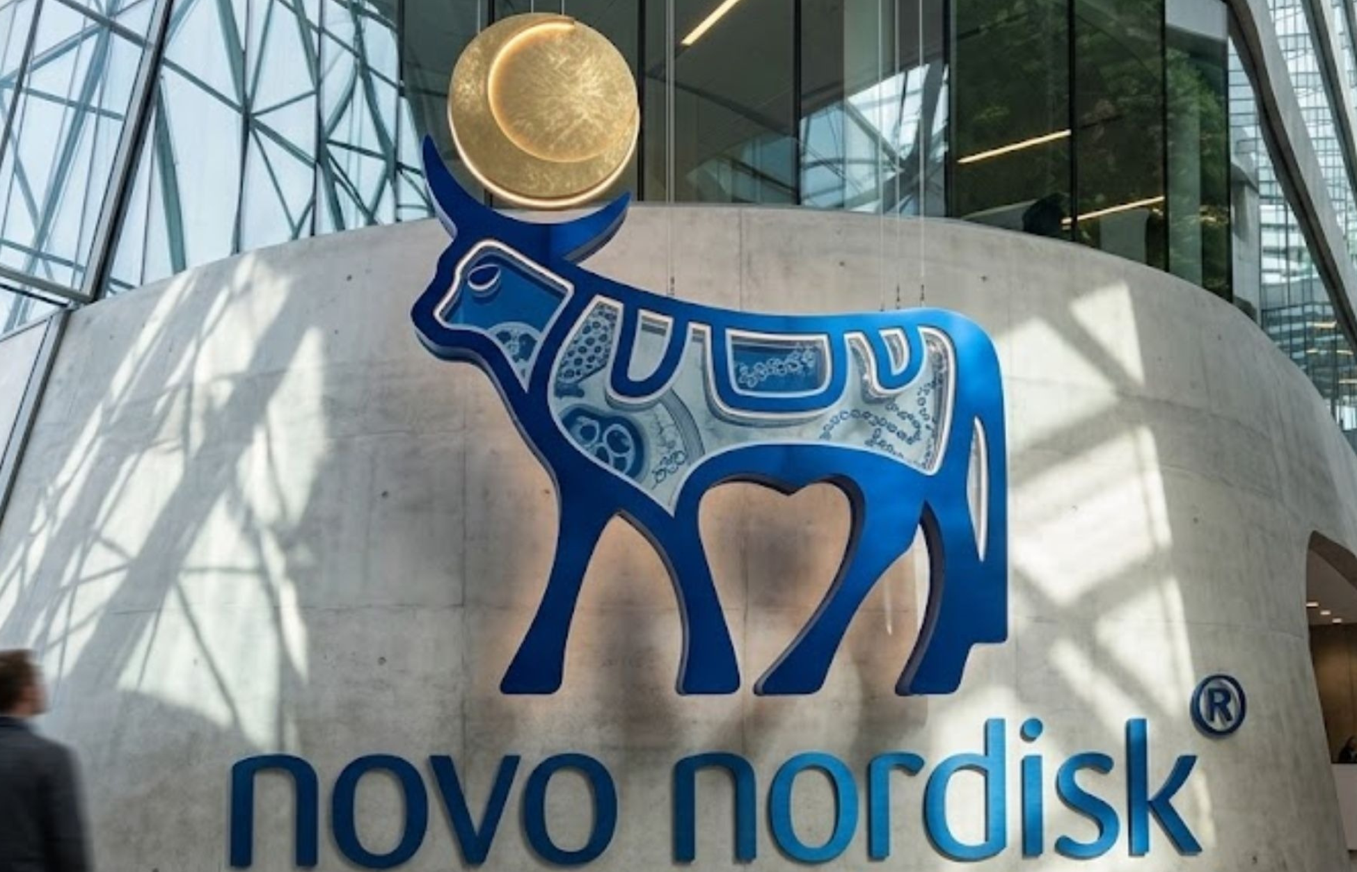 Novo Nordisk corporate logo displayed inside a modern office building, representing the global pharmaceutical company.