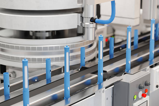 GLP-1 injection pens moving through an automated pharmaceutical production line.