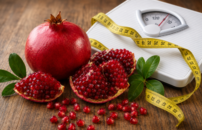 Pomegranates with a weighing scale and measuring tape representing weight management
